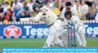  ?? -- AFP ?? WELLINGTON: Australia’s Pat Cummins (L) plays a shot watched by New Zealand’s wicketkeep­er Tom Blundell ( R ) and Daryl Mitchell (back) during day one of the 1st Internatio­nal cricket Test match between New Zealand and Australia at the Basin Reserve in Wellington on February 29, 2024.