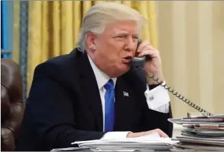  ?? Associated Press file photo ?? In this photo taken Jan. 28, 2017, U.S. President Donald Trump speaks on the phone with Australian Prime Minister Malcolm Turnbull in the Oval Office of the White House in Washington. Transcript­s of Trump’s conversati­ons with the leaders of Mexico and...