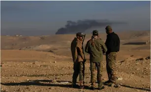  ?? (Alaa al-Marjani/Reuters) ?? RAPID RESPONSE FORCE members confer yesterday during a battle with Islamic Sate insurgents south of Mosul.