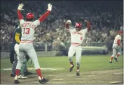  ?? PHOTO BY GETTY IMAGES ?? The Cincinnati Reds’ Joe Morgan (8) heads for home plate as teammate Dave Concepcion (13) tells him not to slide during the World Series against the Oakland Athletics at Oakland-Alameda County Coliseum in October 1972.