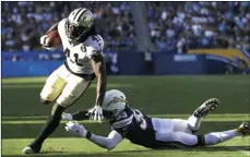  ?? AP PHOTO/MARCIO JOSE SANCHEZ ?? New Orleans Saints running back Alvin Kamara gets away from Los Angeles Chargers defensive back Derwin James during the first half of an NFL preseason football game on Saturday, in Carson, Calif.