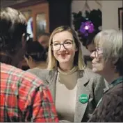  ?? Marcio Jose Sanchez Associated Press ?? AMY KLOBUCHAR’S daughter, Abigail Bessler, talks with Democrats in Stanton, Iowa, on Tuesday as her mother attends President Trump’s Senate trial.