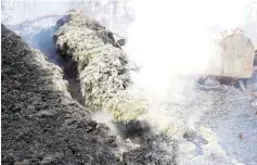  ??  ?? Volcanic gases rise from a fissure near the remains of a structure in the Leilani Estates. — Reuters photo