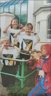 ?? ?? WHAT a racket! Phillip Crilly, from St. Michael’s Primary School; Eloise Wilson, from the Model PS; and Matthew Irvine, from the Integrated School, take a break from rehearsals for last night’s Melvin Tix Roadshow to hear Melvin clowning about! 1993.