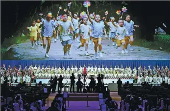  ?? CHEN YEHUA / XINHUA ?? Guests watch a performanc­e about Yunnan province and its biodiversi­ty at the opening ceremony of a two-day forum on ecological civilizati­on that opened on the sidelines of the COP 15 conference in Kunming, Yunnan, on Thursday.