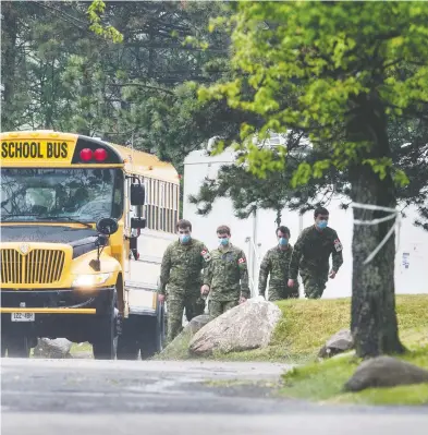  ?? PETER J THOMPSON / NATIONAL POST ?? Canadian soldiers prepare to board a bus Thursday outside of Altamont Care Community in Scarboroug­h, Ont.