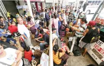  ??  ?? EARLY BIRDS – Crowds begin to swell at the Araneta Bus Terminal in Cubao, Quezon City, Saturday, as passengers wait for buses to the provinces. Rides out of Metro Manila were fully booked by Saturday. (Alvin Kasiban)