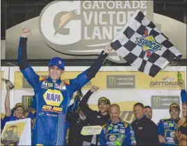  ?? The Associated Press ?? Chase Elliott celebrates in Victory Lane after winning the first of two NASCAR qualifying races for Sunday’s Daytona 500 at Daytona Internatio­nal Speedway in Daytona Beach, Fla., on Thursday.