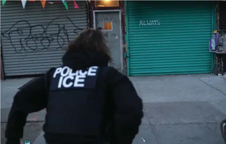  ?? GETTY IMAGES FILE ?? ROUND ’EM UP: U.S. Immigratio­n and Customs Enforcemen­t officers look to arrest an illegal immigrant during an operation in Brooklyn, N.Y., in April, while other ICE officers, below, make an arrest during a targeted enforcemen­t operation in L.A. in 2017, aimed at immigratio­n fugitives, re-entrants and at-large criminal aliens.