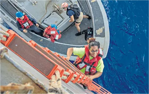  ??  ?? Tasha Fuiava, one of the two women rescued by the US Navy, climbs aboard the USS Ashland after five months lost in the Pacific. Ms Fuiaba and Jennifer Appel, were 5,000 miles off course