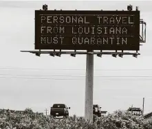  ?? Brett Coomer / Staff photograph­er ?? A sign along Interstate 45 North warns that Texas will enforce quarantine orders to Louisiana drivers entering the state.