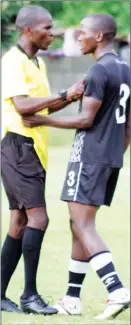  ?? (File pic) ?? Moneni Pirates defender Menzi ‘Magawugawu’ Simelane manhandlin­g Referee Wandile Mamba.