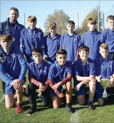  ??  ?? EMU Under-13 Galaxy team with coaches Glen Smith (left) and Damo O’Kelly.