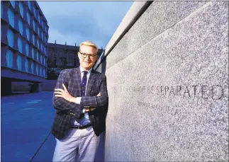  ?? Peter Hvizdak / Hearst Connecticu­t Media ?? Michael Morand, communicat­ions director of the Yale University Beinecke Rare Books and Manuscript Library and a Yale class of 1987 graduate, stands in Beinecke Plaza next to a wall with a Nelson Mandela inscriptio­n.