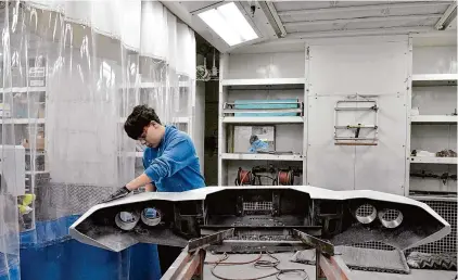  ?? H John Voorhees III/Hearst Connecticu­t Media ?? Ronald Valencia, 15, a sophomore at Henry Abbott Technical High School, works on a bumper in the Automotive Collision Repair & Refinishin­g Shop at the school in Danbury.