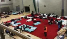  ?? AP PHOTO ?? People gather in a leisure centre in Swiss Cottage, north London, Saturday, after the local council evacuated some 650 homes overnight. Camden Borough Council said in a statement Saturday that it housed many of the residents at two temporary shelters...