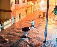  ?? PTI ?? FLOODED WaY: People wade through waterlogge­d street as heavy monsoon rains cause flood in Jabalpur. —