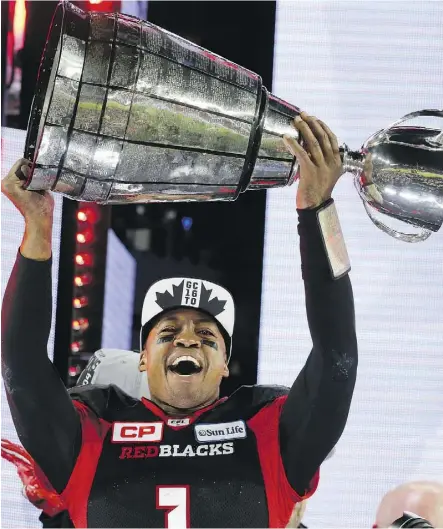  ?? MICHAEL PEAKE ?? Henry Burris hoists the Grey Cup last November after Ottawa’s win over Calgary. The retired pivot will take the trophy to London’s Trafalgar Square on Canada Day as part of 150th-birthday celebratio­ns.