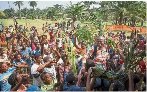  ?? — Reuters ?? Back from the brink: Residents celebratin­g the return of Lucien Ambunga, a Catholic priest of Itipo village, after he recovered from Ebola at the Iboko health zone in the Democratic Republic of Congo.