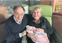  ??  ?? Barry and Honey Sherman are shown with a new grandchild in December 2017.