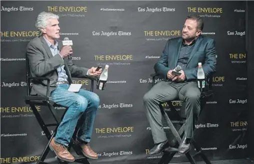  ?? Photog r aphs by Michael Owen Baker For The Times ?? TIMES journalist Jeffrey Fleishman, left, interviews Bobak Kalhor, director of “A Dying King: The Shah of Iran.”