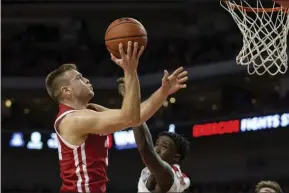  ?? JOHN PETERSON - THE ASSOCIATED PRESS ?? Wisconsin guard Brad Davison (34) makes a lay up against Nebraska forward Kevin Cross (1) during the first half of an NCAA college basketball game in Lincoln, Neb., Saturday, Feb. 15, 2020.