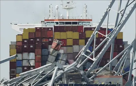  ?? Steve Helber/Associated Press ?? The container ship Dali is stuck under part of the Francis Scott Key Bridge on March 26 after the ship hit the bridge in Baltimore. The FBI on Monday boarded the Dali, which struck the bridge and resulted in the deaths of six constructi­on workers, as part of an investigat­ion into the deadly collapse.