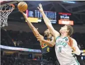  ?? RON SCHWANE AP ?? Cavaliers forward Evan Mobley gets past Bucks center Brook Lopez during the second half Saturday.