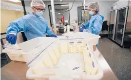  ?? GREGORY BULL/AP ?? Technician­s Welney Huang, right, and Nguyen Nguyen process breast milk at the University of California Health Milk Bank in San Diego on Friday. The formula shortage has sparked a surge of interest among moms in donating breast milk to help bridge the supply gap.