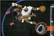  ?? MATT SLOCUM — THE ASSOCIATED PRESS ?? The Pelicans’ James Johnson, right, goes up for a shot against the 76ers’ Joel Embiid in the second half Friday