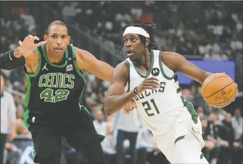  ?? ASSOCIATED PRESS — MORRY GASH/THE ?? Milwaukee Bucks' Jrue Holiday drives past Boston Celtics' Al Horford during Game 4 Monday night.