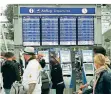  ?? FOTO: DPA ?? Passagiere stehen im Flughafen Düsseldorf vor einer Abflugtafe­l.