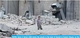  ?? —AFP ?? HAZEH, Syria: A Syrian child roams the streets in the town of Hazzeh in Eastern Ghouta, on the outskirts of the Syrian capital Damascus.