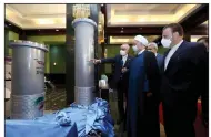  ?? (AP/Iranian Presidency Office) ?? Ali Akbar Salehi, head of the Atomic Energy Organizati­on of Iran, speaks Saturday as President Hassan Rouhani (second from left) visits a Tehran exhibition of the country’s nuclear achievemen­ts.