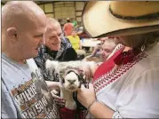  ??  ?? Karen Hoskins shows Willie the alpaca to Bruce and Johnny on a visit in early August.