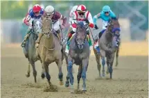  ?? AP PHOTO/NICK WASS ?? Jose Ortiz, second from right, heads to the finish line in the Preakness Stakes on Saturday. Early Voting finished first in a nine-horse field, winning the 1 3/16-mile race in 1 minute, 54.54 seconds.