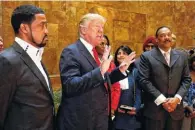  ?? ASSOCIATED PRESS FILE PHOTO ?? Pastor Darrell Scott, left, listens as Republican presidenti­al candidate Donald Trump speaks April 18 in Trump Tower.
