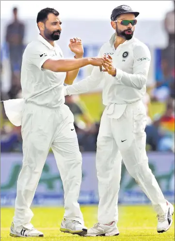  ??  ?? Mohammed Shami (left) celebrates with captain Virat Kohli after dismissing Kusal Mendis in the Galle Test on Thursday.