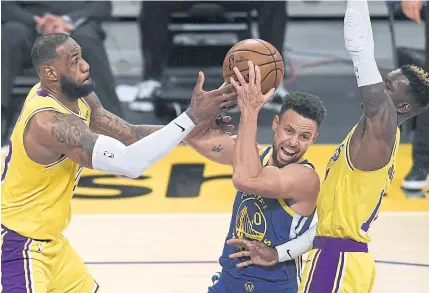  ?? AFP ?? The Lakers’ LeBron James, left, vies for the ball with Golden State’s Stephen Curry during a game last season.