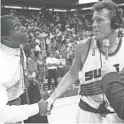  ?? ROB SCHUMACHER/AZCENTRAL SPORTS ?? Suns Dan Majerle, right as congratula­ted by TV announcer and former NBA great Magic Johnson during the 1993 Western Conference finals.