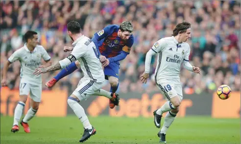  ?? MANU FERNANDEZ / AP ?? Barcelona's Lionel Messi collides with Real Madrid's Sergio Ramos during the teams’ 1-1 La Liga draw at Camp Nou on Saturday.