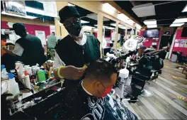  ?? JULIO CORTEZ — THE ASSOCIATED PRESS ?? Wallace Wilson cuts the hair of James McRae on April 9 in Hyattsvill­e, Md. Wilson is a member of the Health Advocates In Reach & Research (HAIR) program, which helps barbers and hair stylists to get certified to talk to community members about health.