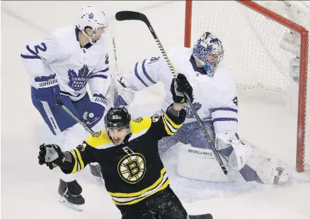  ?? ELISE AMENDOLA/THE ASSOCIATED PRESS ?? Boston Bruins left-winger Brad Marchand celebrates his goal against Toronto Maple Leafs goalie Frederik Andersen as Maple Leafs defenceman Ron Hainsey looks on during Boston’s 5-1 win at TD Garden Thursday in Game 1 of their opening-round series.