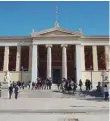  ??  ?? Students gather outside the entrance to the 19th century Athens University building on Panepistim­iou Street in the center of the Greek capital.