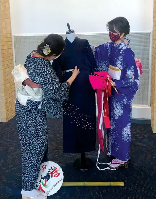  ?? Submitted photo ?? ▪ Mayumi and Mary Staton present a kimono demonstrat­ion at the fourth annual Cherry Blossom Festival on Sunday.