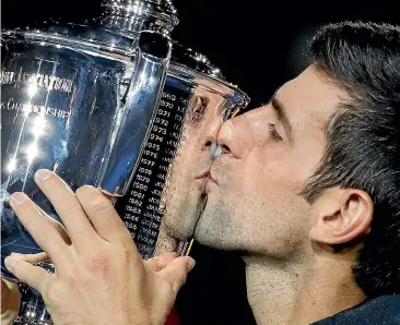  ?? AP ?? Novak Djokovic kisses the US Open men’s singles trophy after beating Juan Martin del Potro in the final in New York yesterday.