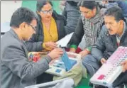  ?? AFP FILE ?? Election officials examine an electronic voting machines at a distributi­on centre in Amritsar.