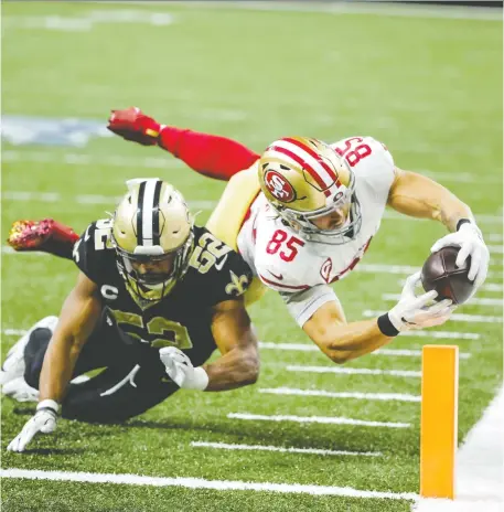  ?? DERICK E. HINGLE/USA TODAY SPORTS ?? San Francisco 49ers tight end George Kittle dives past New Orleans Saints linebacker Craig Robertson for a touchdown during the second half of a wild 48-46 San Francisco win at the Mercedes-Benz Superdome. The victory improved the 49ers to 11-2.