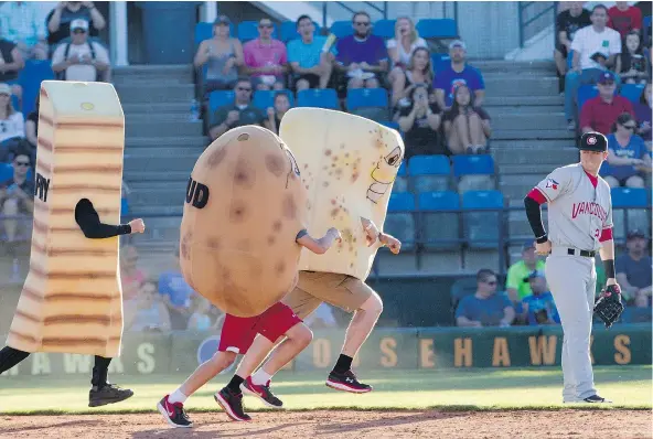  ?? — THE ASSOCIATED PRESS FILES ?? Vancouver Canadians second baseman Mattingly Romanin can’t help but be a little amused as racing potatoes run the bases between innings in Idaho in July. On Canada Day, the C’s lone Canadian player clubbed a grand slam in a 7-0 victory.