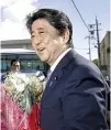  ?? REUTERS ?? JAPANESE Prime Minister Shinzo Abe smiles as he receives a bouquet after announcing his candidacy for the ruling Liberal Democratic Party leadership election in Tarumizu, Kagoshima Prefecture, Japan in this Aug. 26 photo taken by Kyodo.